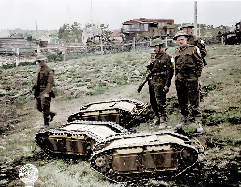 British soldiers stand next to captured German Goliaths (colorized)