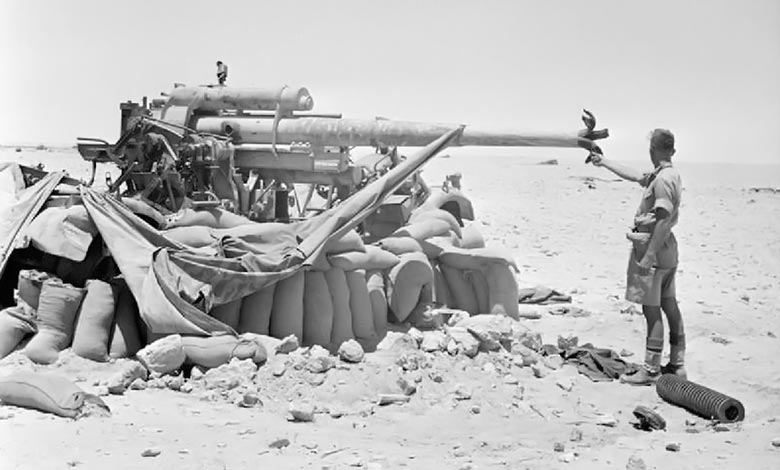 Charles Upham VC & Bar standing in front of a captured 88mm German FlaK near El Alamein, 17 July 1942