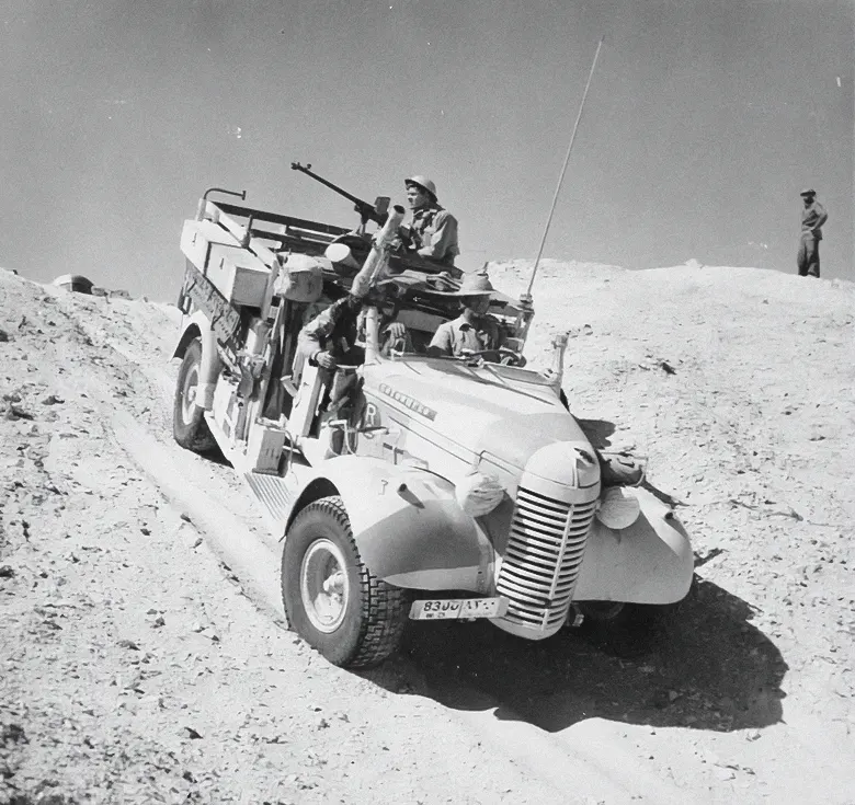 A Long Range Desert Group truck negotiates the slope of a sand dune during a patrol in the desert