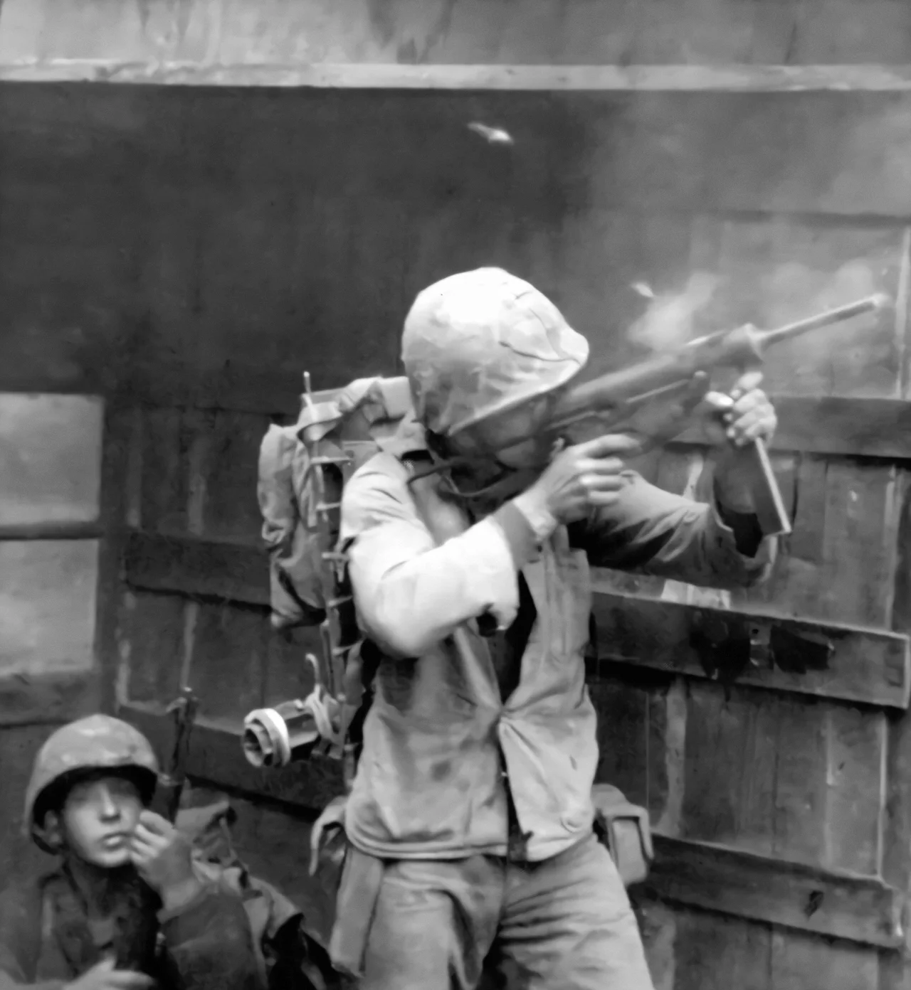 A United States Marine suppresses North Korean sniper fire with the M3 Grease Gun in Seoul, September 1950